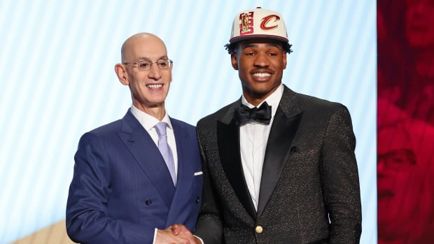 Jun 23, 2022; Brooklyn, NY, USA; Ochai Agbaji (Kansas) shakes hands with NBA commissioner Adam Silver after being selected as the number fourteen overall pick by the Cleveland Cavaliers in the first round of the 2022 NBA Draft at Barclays Center.