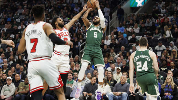 Apr 27, 2022; Milwaukee, Wisconsin, USA; Milwaukee Bucks guard Jevon Carter (5) shoots against Chicago Bulls guard Coby White (0) during the second quarter during game five of the first round for the 2022 NBA playoffs at Fiserv Forum.