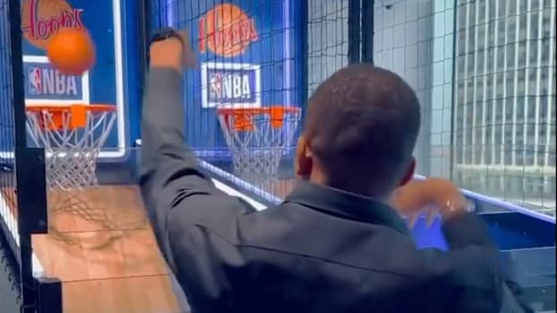 Kylian Mbappe pictured shooting a basketball left-handed