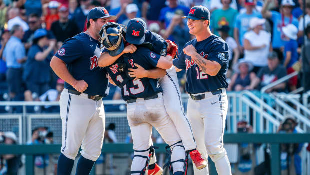 Ole Miss Rebels infielder Ben Van Cleve (33), catcher Hayden Dunhurst (13), starting pitcher Dylan DeLucia (44) and designated hitter Kemp Alderman (12) celebrate after defeating the Arkansas Razorbacks to advance to the final series of the College World Series at Charles Schwab Field.