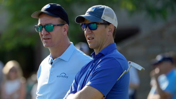 Eli and Peyton Manning at a golf tournament.