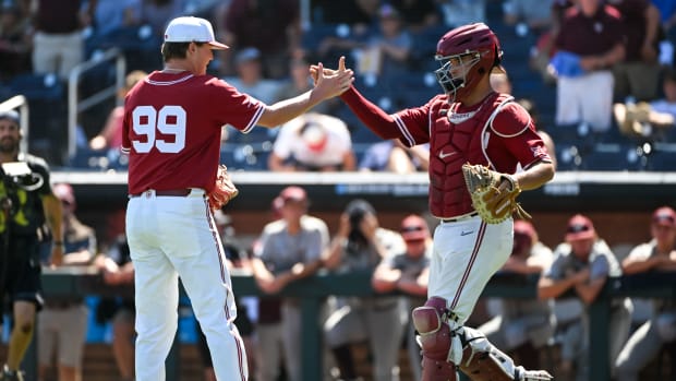 Jun 22, 2022; Omaha, NE, USA; Oklahoma Sooners pitcher Trevin Michael (99) greets catcher Jimmy Crooks (3) after the win against the Texas A&M Aggies at Charles Schwab Field.