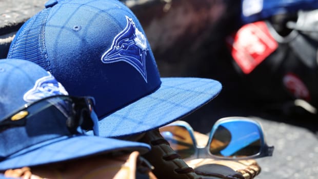 Blue Jays spring training hats in the dugout.