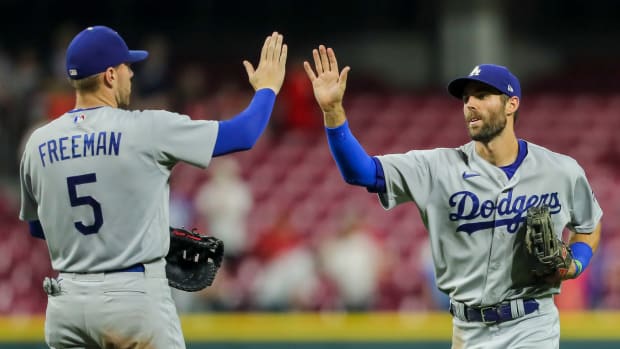 Los Angeles Dodgers left fielder Chris Taylor (3) high fives first baseman Freddie Freeman (5) after the win over the Cincinnati Reds at Great American Ball Park.