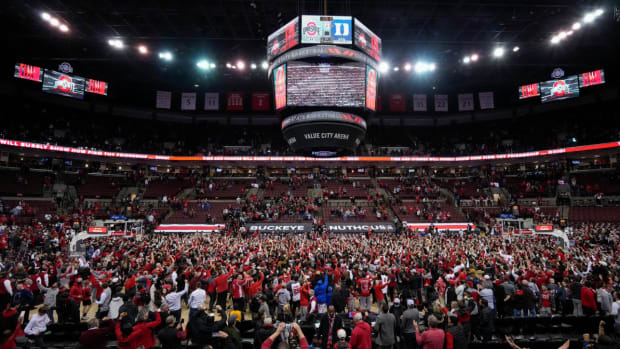 Ohio State fans storm the court following the Buckeyes’ 71-66 win over the Duke Blue Devils in the NCAA men’s basketball game at Value City Arena in Columbus on Wednesday, Dec. 1, 2021. Duke At Ohio State Big Ten Acc Challenge
