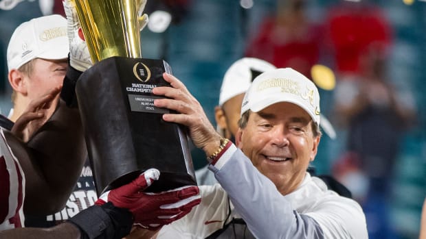 Alabama Crimson Tide head coach Nick Saban celebrates with the trophy after defeating the Ohio State Buckeyes in the 2021 College Football Playoff National Championship Game.
