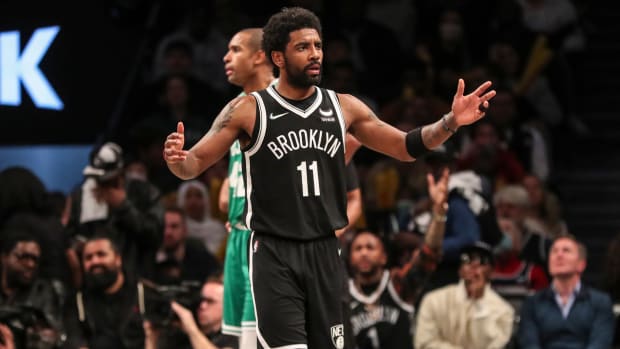 Nets guard Kyrie Irving (11) looks towards an official after a call in the third quarter of a game against the Celtics.
