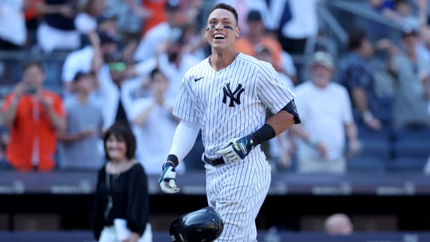 Yankees outfielder Aaron Judge (99) tosses his helmet as he comes home after hitting a game-winning walk-off three-run home run against the Astros.