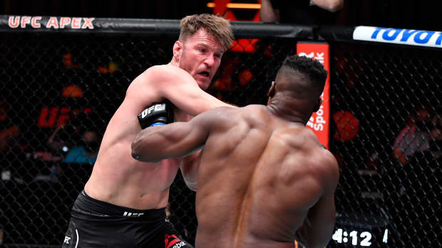 Stipe Miocic punches Francis Ngannou of Cameroon in their UFC heavyweight championship fight during the UFC 260 event at UFC APEX on March 27, 2021 in Las Vegas, Nevada.