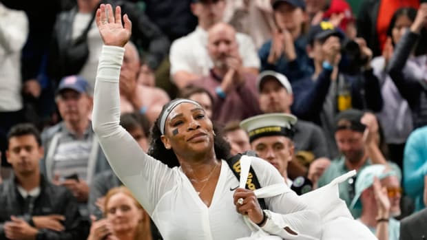 Serena Williams waves as she leaves the court after losing to France's Harmony Tan in a first round women's singles match on day two of Wimbledon.