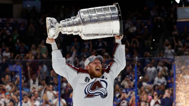 Avalanche left wing and captain Gabriel Landeskog (92) celebrates his team’s victory in the Stanley Cup final by lifting the Stanley Cup over his head.