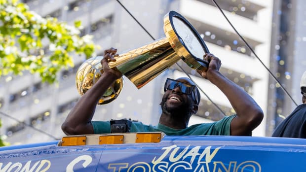 Warriors forward Draymond Green holds the Larry O’Brien trophy during the NBA Championship parade in San Francisco.