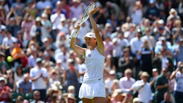 Polish tennis player Iga Swiatek applauds to the crowd after a match at Wimbledon.