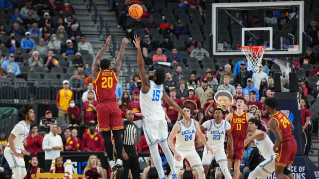 Mar 11, 2022; Las Vegas, NV, USA; USC Trojans guard Ethan Anderson (20) shoots against UCLA Bruins center Myles Johnson (15) during the second half at T-Mobile Arena.