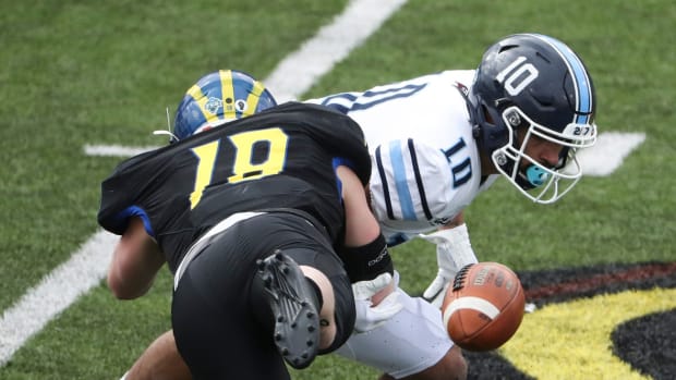 Delaware linebacker Matt Palmer disrupts a pitch reception by Maine's Andre Miller, foiling a Black Bear fourth down bid in the second half of the Blue Hens' 37-0 win at Delaware Stadium, Saturday, March 6, 2021.