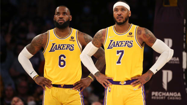 Mar 13, 2022; Phoenix, Arizona, USA; Los Angeles Lakers forward LeBron James (6) and forward Carmelo Anthony (7) argue a call with an official during the first half of the game against the Phoenix Suns at Footprint Center. Mandatory Credit: Joe Camporeale-USA TODAY Sports
