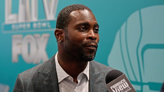 Michael Vick speaks into a microphone