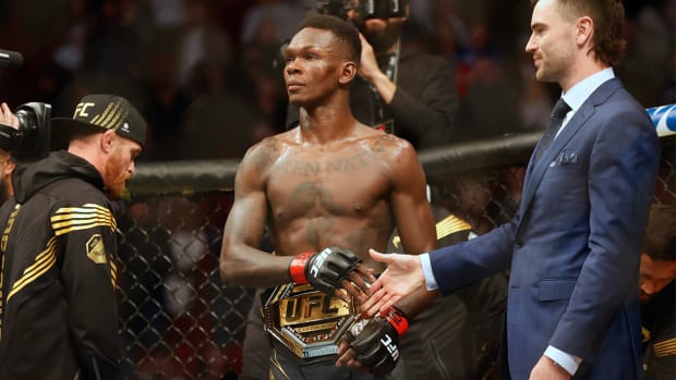 Feb 12, 2022; Houston, Texas, UNITED STATES; Israel Adesanya (red gloves) reacts after the fight against Robert Whittaker (blue gloves) during UFC 271 at Toyota Center.