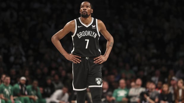 Nets forward Kevin Durant with his hands on his hips during a game.