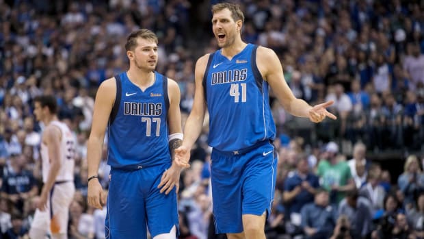 Luka Dončić and Dirk Nowitzki share the court during a Dallas Mavericks game.