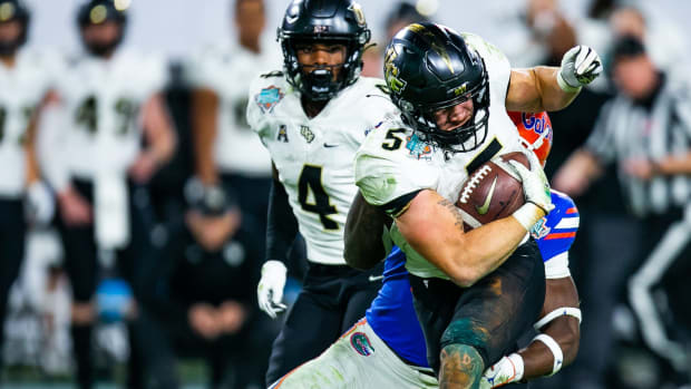 UCF Knights running back Isaiah Bowser (5) tries to educe Florida Gators safety Trey Dean III (0). The UCF Knights defeats the Florida Gators, 29-17 in the Gasparilla Bowl Thursday, December 23, 2021, at Raymond James Stadium in Tampa, FL.