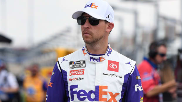 Jun 25, 2022; Nashville, Tennessee, USA; NASCAR Cup Series driver Denny Hamlin (11) walks to his car during qualifying for the Ally 400 at Nashville Superspeedway.
