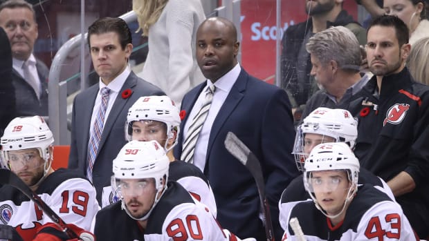 Devils assistant coaches Rick Kowalsky and Mike Grier look on from behind the bench as center Travis Zajac (19) and left wing Taylor Hall (9) and left wing Marcus Johansson (90) watch a game against the Maple Leafs.