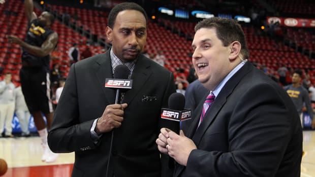 ESPN television personality Stephen A. Smith (left) and sportswriter Brian Windhorst (right) before an NBA game.