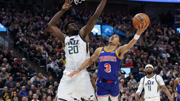 Golden State Warriors guard Jordan Poole (3) is fouled by Utah Jazz center Udoka Azubuike (20) while shooting during the first quarter at Vivint Arena.