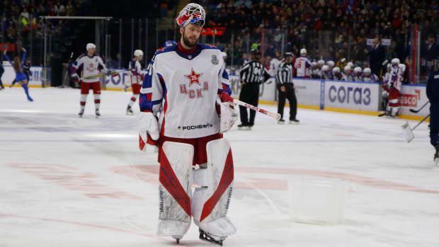 CSKA and Russian goalie Ivan Fedotov skates with his helmet sitting atop his head during a KHL game.