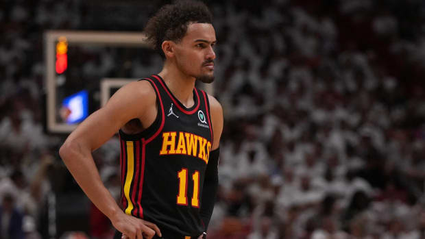 Hawks point guard Trae Young with his hands on his hips during a game.