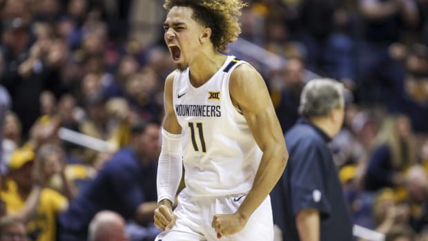 Feb 29, 2020; Morgantown, West Virginia, USA; West Virginia Mountaineers forward Emmitt Matthews Jr. (11) celebrates after a play during the second half against the Oklahoma Sooners at WVU Coliseum.