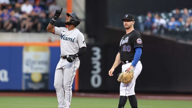 Jul 8, 2022; New York City, New York, USA; Miami Marlins left fielder Bryan De La Cruz (14) reacts after hitting an RBI double during the second inning in front of New York Mets first baseman Pete Alonso (20) at Citi Field. Mandatory Credit: Vincent Carchietta-USA TODAY Sports