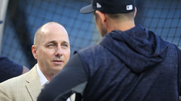 New York Yankees GM Brian Cashman looks at manager Aaron Boone