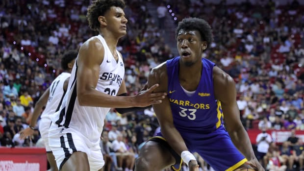 James Wiseman #33 of the Golden State Warriors drives against Dominick Barlow #26 of the San Antonio Spurs during the 2022 NBA Summer League at the Thomas & Mack Center on July 10, 2022 in Las Vegas, Nevada.