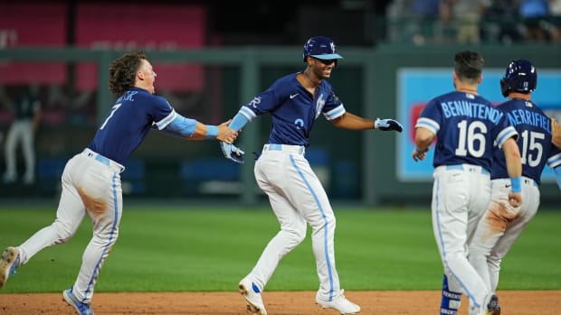 Jul 8, 2022; Kansas City, Missouri, USA; Kansas City Royals center fielder Michael A. Taylor (middle) is congratulated by teammates after hitting a walk-off single to defeat the Cleveland Guardians during the ninth inning at Kauffman Stadium. Mandatory Credit: Jay Biggerstaff-USA TODAY Sports