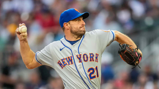 Jul 11, 2022; Cumberland, Georgia, USA; New York Mets starting pitcher Max Scherzer (21) pitches against the Atlanta Braves during the third inning at Truist Park.