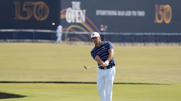 Jul 11, 2022; St. Andrews, Fife, SCT; Bryson DeChambeau chips onto the 17th green during a practice round for the 150th Open Championship golf tournament at St. Andrews Old Course.