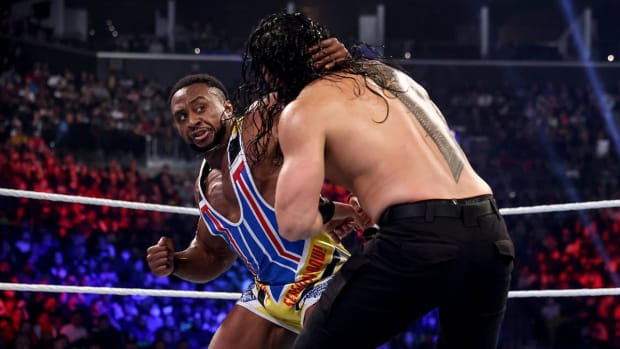 Big E delivers a punch to Roman Reigns