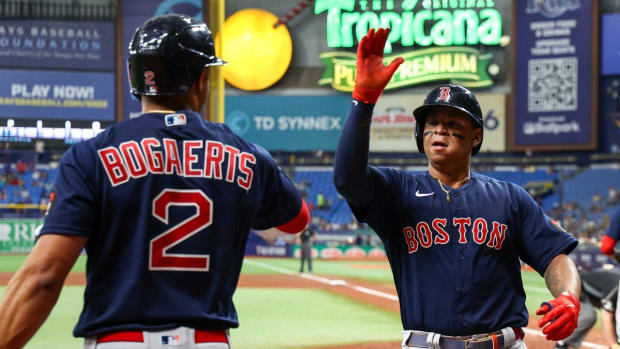 Jul 14, 2022; St. Petersburg, Florida, USA; Boston Red Sox third baseman Rafael Devers (11) is congratulated by shortstop Xander Bogaerts (2) after hitting a home run against the Tampa Bay Rays in the fourth inning at Tropicana Field. Mandatory Credit: Nathan Ray Seebeck-USA TODAY Sports