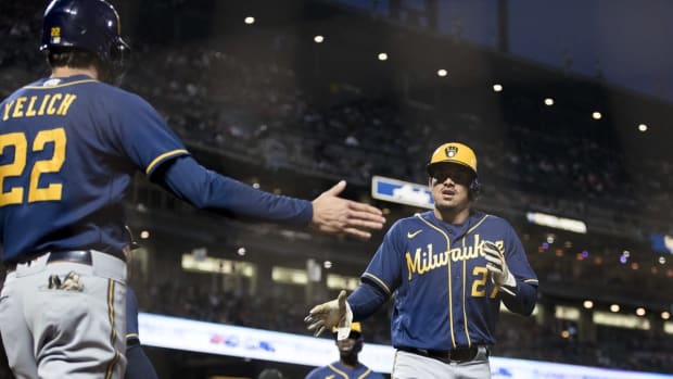 Jul 15, 2022; San Francisco, California, USA; Milwaukee Brewers shortstop Willy Adames (27) celebrates with left fielder Christian Yelich (22) after scoring against the San Francisco Giants during the fifth inning at Oracle Park. Mandatory Credit: John Hefti-USA TODAY Sports