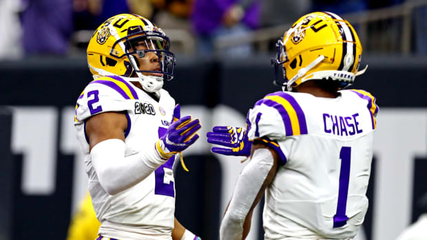 Jan 13, 2020; New Orleans, Louisiana, USA; LSU Tigers wide receiver Justin Jefferson (2) and LSU Tigers wide receiver Ja'Marr Chase (1) celebrate after a play during the second quarter against the Clemson Tigers in the College Football Playoff national championship game at Mercedes-Benz Superdome. Mandatory Credit: Matthew Emmons-USA TODAY Sports