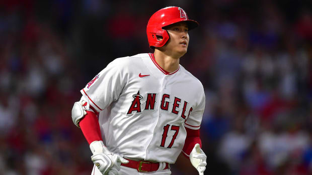 Jul 16, 2022; Anaheim, California, USA; Los Angeles Angels designated hitter Shohei Ohtani (17) reaches first on a fielding error committed by Los Angeles Dodgers first baseman Freddie Freeman (5) during the third inning at Angel Stadium.