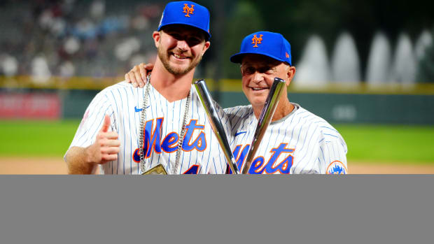 Jul 12, 2021; Denver, CO, USA; New York Mets first baseman Pete Alonso poses for photographs with bench coach Dave Jauss and the winners trophy following his victory in the 2021 MLB Home Run Derby.