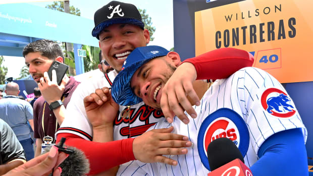 Jul 18, 2022; Los Angeles, CA, USA;  Chicago Cubs catcher Willson Contreras (40) is interviewed as his brother, Atlanta Braves designated hitter William Contreras (24) sneaks up behind him at All Star-Media Day at Dodger Stadium.