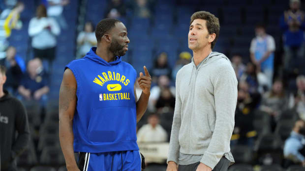 Mar 8, 2022; San Francisco, California, USA; Golden State Warriors forward Draymond Green (23) talks to general manager Bob Myers before the game against the LA Clippers at Chase Center. Mandatory Credit: Darren Yamashita-USA TODAY Sports