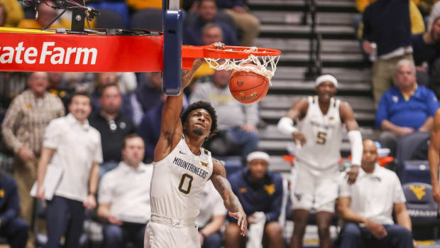 Feb 8, 2022; Morgantown, West Virginia, USA; West Virginia Mountaineers guard Kedrian Johnson (0) dunks the ball during the second half against the Iowa State Cyclones at WVU Coliseum.