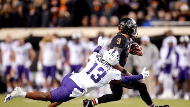 Oklahoma State's Spencer Sanders (3) is tackled by TCU's Dee Winters in the second quarter during the college football game between the Oklahoma State Cowboys and TCU Horned Frogs at Boone Pickens Stadium in Stillwater, Okla., Saturday, Nov. 13, 2021.