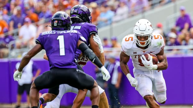 Oct 2, 2021; Fort Worth, Texas, USA; Texas Longhorns running back Bijan Robinson (5) runs with the ball as TCU Horned Frogs cornerback Tre'Vius Hodges-Tomlinson (1) defends during the second half at Amon G. Carter Stadium.