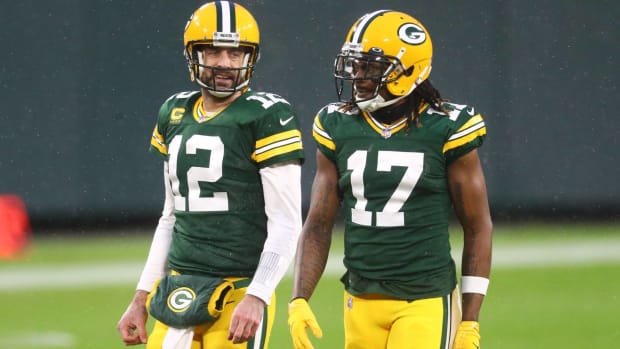 Packers quarterback Aaron Rodgers and wide receiver Davante Adams speak during a game.